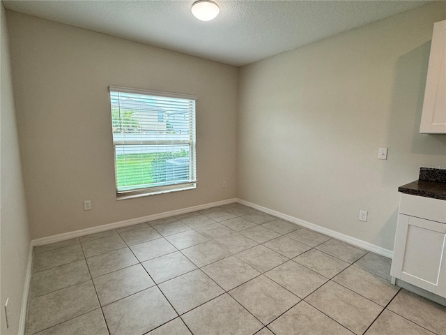 4448 Globe Thistle, Tampa, FL 33619 - unfurnished dining area with light tile patterned floors and a textured ceiling