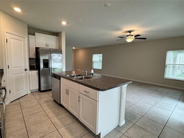 4448 Globe Thistle, Tampa, FL 33619 - kitchen featuring stainless steel appliances, dark countertops, light tile patterned floors, white cabinets, and recessed lighting