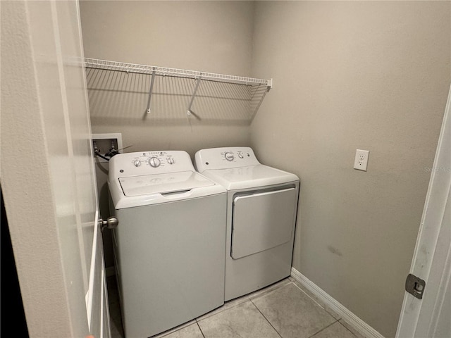 4448 Globe Thistle, Tampa, FL 33619 - washroom with washing machine and clothes dryer and light tile patterned floors