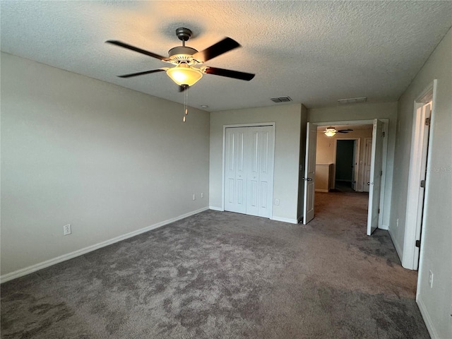 4448 Globe Thistle, Tampa, FL 33619 - unfurnished bedroom with a textured ceiling, dark colored carpet, a closet, and ceiling fan