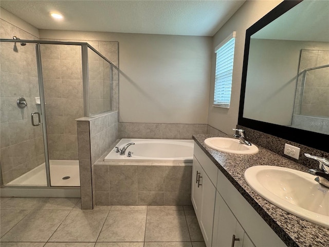 4448 Globe Thistle, Tampa, FL 33619 - bathroom featuring a garden tub, a shower stall, double vanity, tile patterned floors, and a textured ceiling