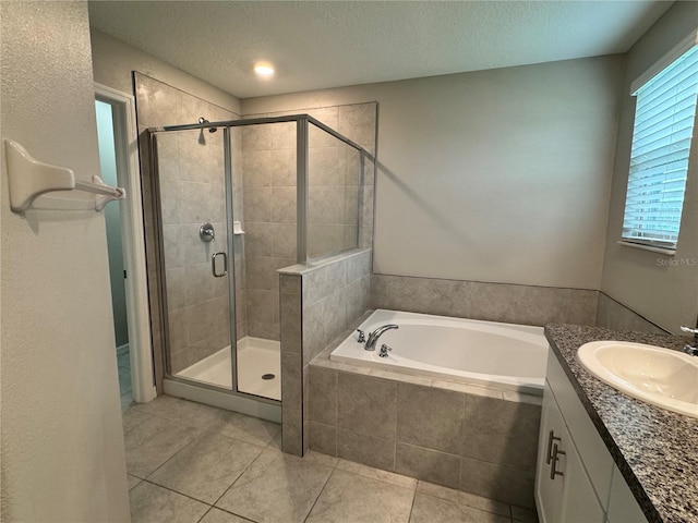 4448 Globe Thistle, Tampa, FL 33619 - bathroom with a bath, a stall shower, vanity, tile patterned floors, and a textured ceiling