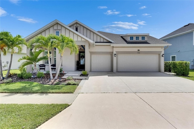 7420 Paradiso Dr, Apollo Beach, FL 33572 - view of front facade featuring a garage, driveway, a shingled roof, and stucco siding