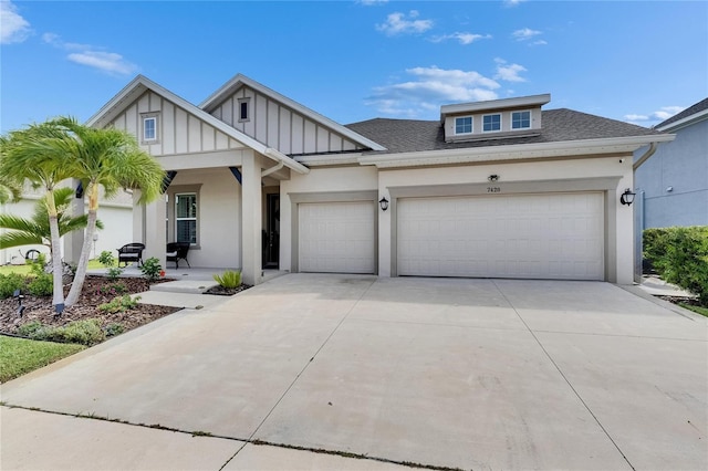 7420 Paradiso Dr, Apollo Beach, FL 33572 - view of front facade featuring an attached garage, board and batten siding, concrete driveway, a shingled roof, and stucco siding