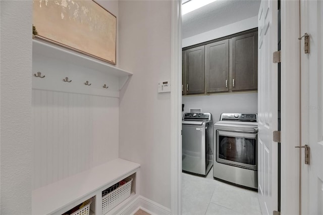 7420 Paradiso Dr, Apollo Beach, FL 33572 - laundry room featuring washer and dryer, cabinet space, and light tile patterned floors