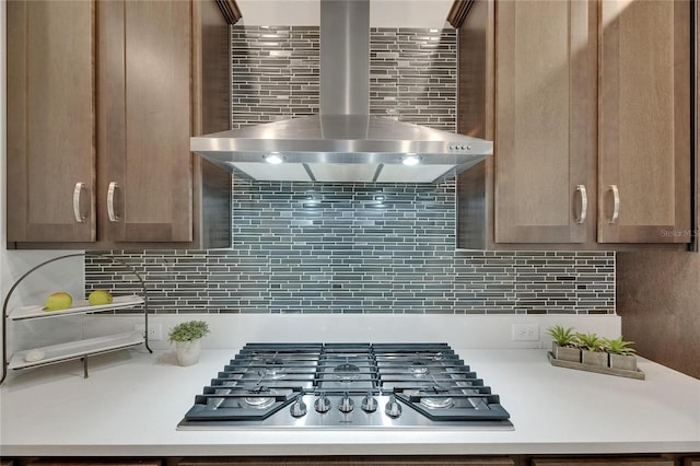 7420 Paradiso Dr, Apollo Beach, FL 33572 - kitchen with wall chimney exhaust hood, stainless steel gas cooktop, light countertops, and decorative backsplash