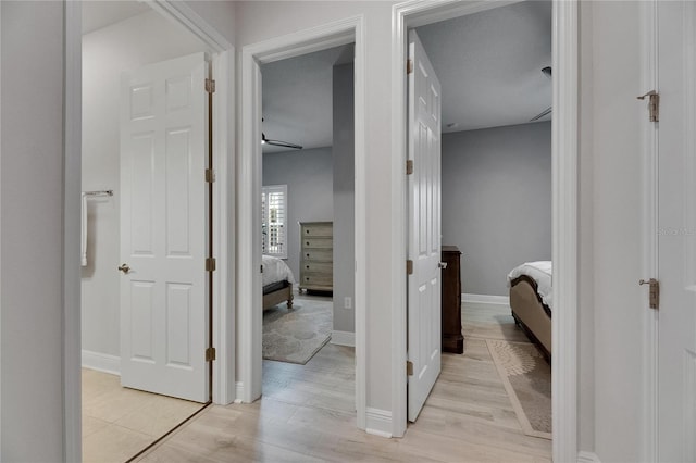7420 Paradiso Dr, Apollo Beach, FL 33572 - corridor featuring light wood-style flooring and baseboards