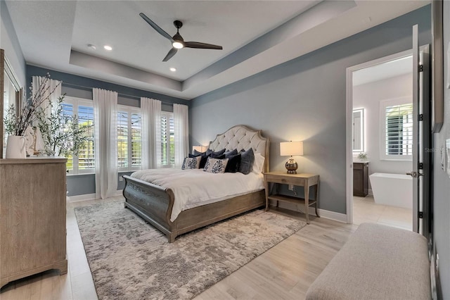 7420 Paradiso Dr, Apollo Beach, FL 33572 - bedroom with a tray ceiling, wood finished floors, recessed lighting, and a ceiling fan