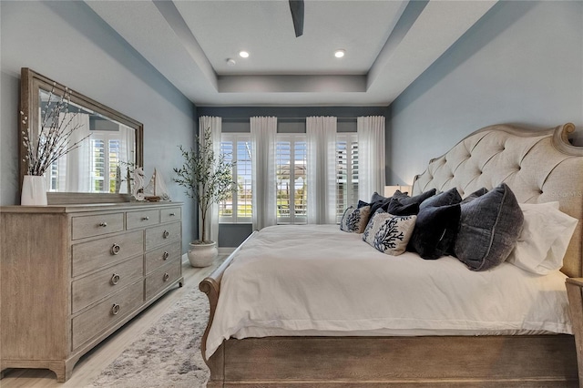 7420 Paradiso Dr, Apollo Beach, FL 33572 - bedroom with light wood-style floors and a raised ceiling