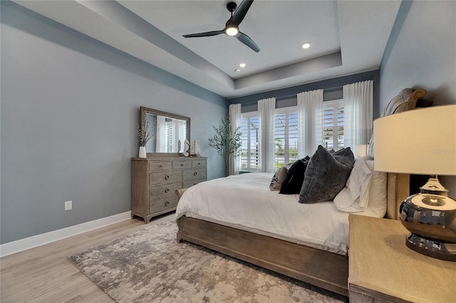7420 Paradiso Dr, Apollo Beach, FL 33572 - bedroom with a tray ceiling, wood finished floors, recessed lighting, and ceiling fan