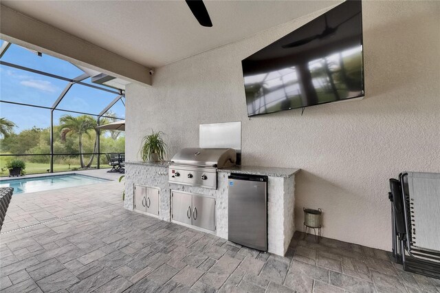 7420 Paradiso Dr, Apollo Beach, FL 33572 - view of patio / terrace with exterior kitchen, ceiling fan, an outdoor pool, and glass enclosure