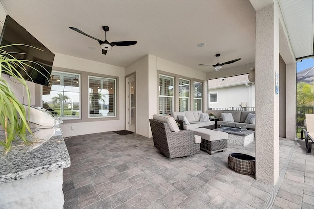 7420 Paradiso Dr, Apollo Beach, FL 33572 - view of patio / terrace with a ceiling fan and an outdoor living space with a fire pit