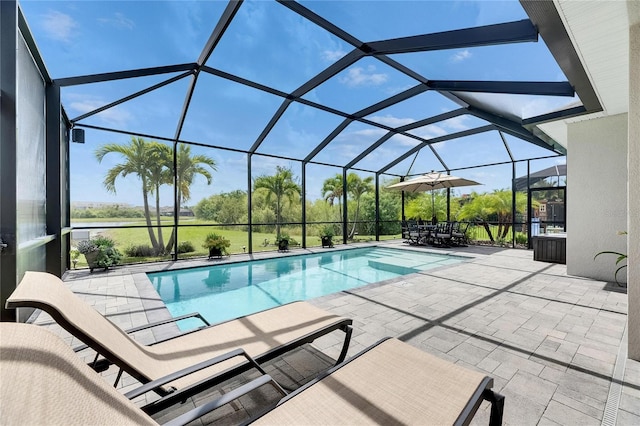 7420 Paradiso Dr, Apollo Beach, FL 33572 - swimming pool featuring a patio area, glass enclosure, and outdoor dining space