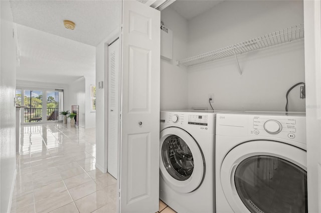 2400 Feather Sound Dr Unit 528, Clearwater, FL 33762 - laundry room with washing machine and dryer and light tile patterned flooring