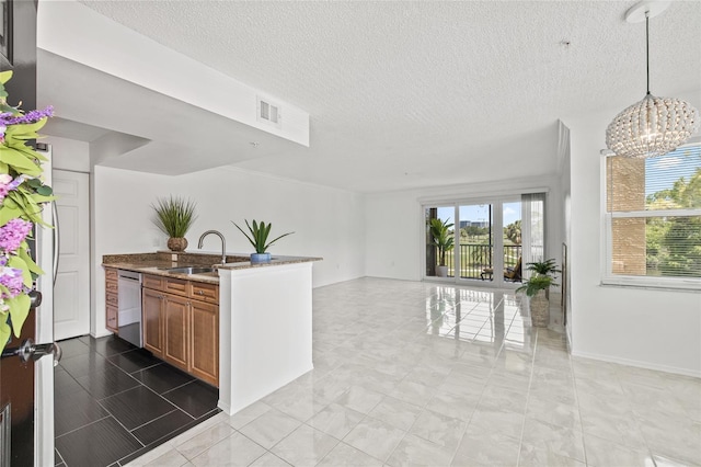 2400 Feather Sound Dr Unit 528, Clearwater, FL 33762 - kitchen with brown cabinets, open floor plan, stainless steel dishwasher, a chandelier, and a textured ceiling