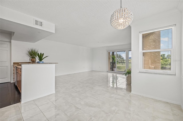 2400 Feather Sound Dr Unit 528, Clearwater, FL 33762 - empty room featuring a textured ceiling and a chandelier