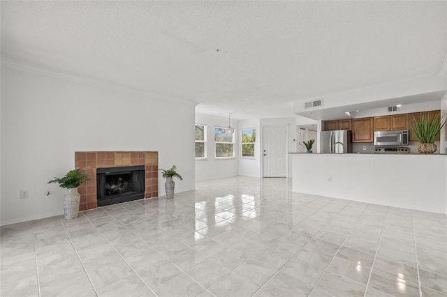 2400 Feather Sound Dr Unit 528, Clearwater, FL 33762 - unfurnished living room with a fireplace and crown molding