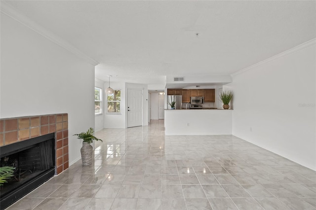 2400 Feather Sound Dr Unit 528, Clearwater, FL 33762 - unfurnished living room featuring a tiled fireplace, crown molding, and light marble finish floors