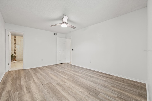 2400 Feather Sound Dr Unit 528, Clearwater, FL 33762 - unfurnished room with light wood-style floors, a ceiling fan, and a textured ceiling