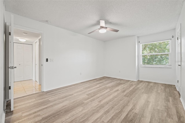 2400 Feather Sound Dr Unit 528, Clearwater, FL 33762 - spare room with light wood finished floors, a ceiling fan, and a textured ceiling