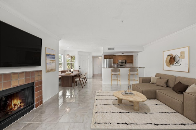 2400 Feather Sound Dr Unit 528, Clearwater, FL 33762 - living area with crown molding, a fireplace, and light marble finish flooring