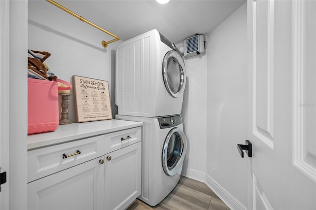 6372 Palma Del Mar Blvd S Unit 601, Saint Petersburg, FL 33715 - washroom featuring estacked washer and dryer, cabinet space, and light wood-type flooring