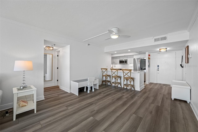 6372 Palma Del Mar Blvd S Unit 601, Saint Petersburg, FL 33715 - living area with ornamental molding, a ceiling fan, dark wood-style floors, a textured ceiling, and recessed lighting