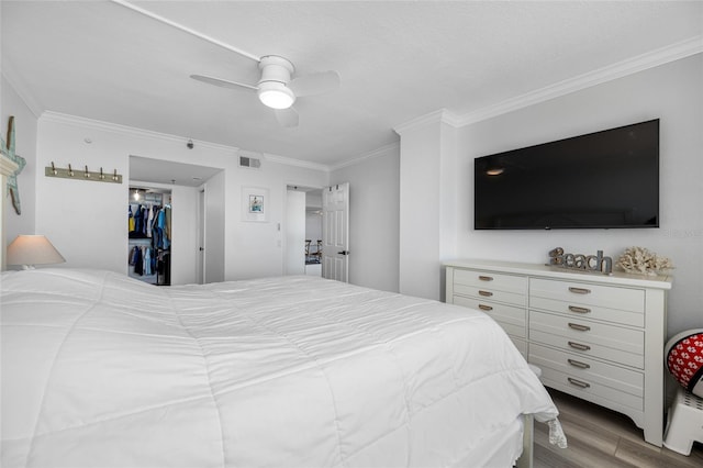 6372 Palma Del Mar Blvd S Unit 601, Saint Petersburg, FL 33715 - bedroom with crown molding, wood finished floors, ceiling fan, and a spacious closet