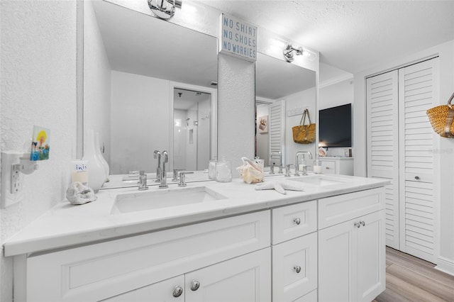 6372 Palma Del Mar Blvd S Unit 601, Saint Petersburg, FL 33715 - full bathroom featuring double vanity, a closet, wood finished floors, and a textured ceiling