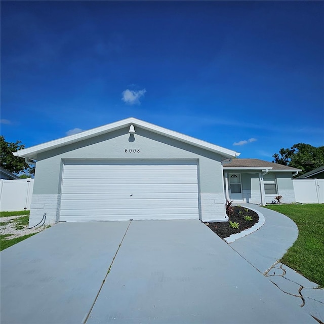 6008 Firefly Ln, Apollo Beach, FL 33572 - single story home featuring brick siding, concrete driveway, and an attached garage