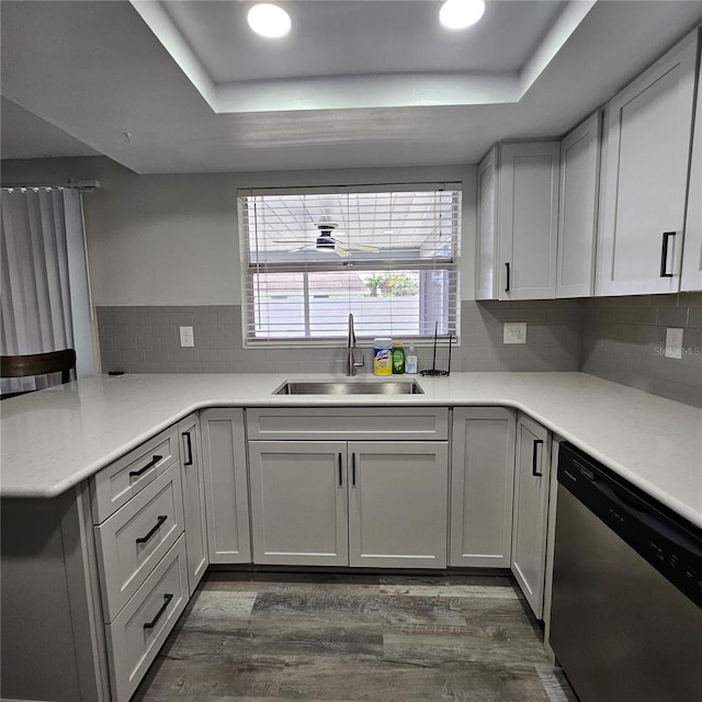 6008 Firefly Ln, Apollo Beach, FL 33572 - kitchen featuring dishwasher, a raised ceiling, dark wood finished floors, a peninsula, and recessed lighting