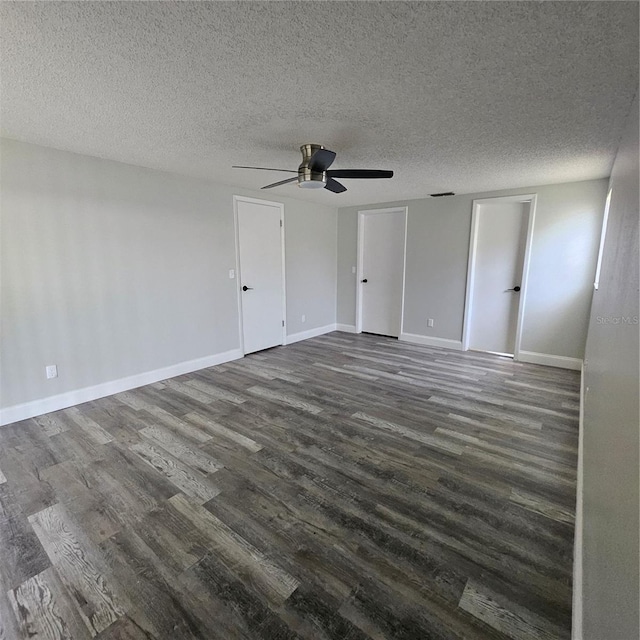 6008 Firefly Ln, Apollo Beach, FL 33572 - unfurnished bedroom featuring dark wood-style flooring, a textured ceiling, and a ceiling fan