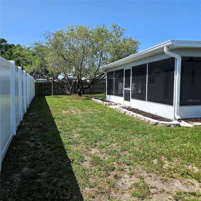 6008 Firefly Ln, Apollo Beach, FL 33572 - fenced backyard with a sunroom