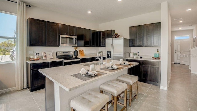 577 Mangrove Shade Cir, Apollo Beach, FL 33572 - kitchen featuring appliances with stainless steel finishes, a sink, plenty of natural light, a breakfast bar area, and recessed lighting