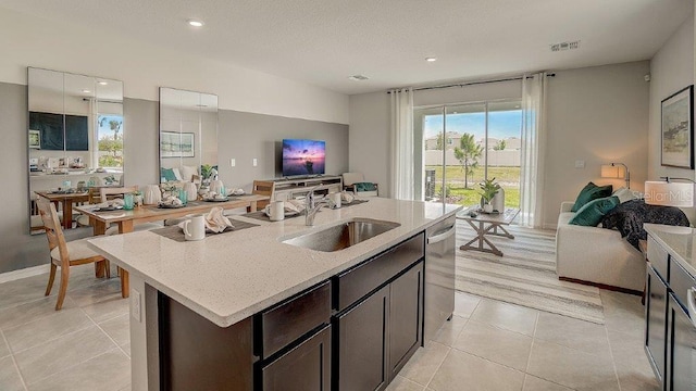 577 Mangrove Shade Cir, Apollo Beach, FL 33572 - kitchen with a sink, open floor plan, light tile patterned floors, light stone countertops, and stainless steel dishwasher