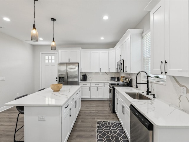 2809 N 21st St, Tampa, FL 33605 - kitchen featuring stainless steel appliances, a kitchen island, backsplash, a breakfast bar, and recessed lighting