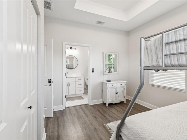 2809 N 21st St, Tampa, FL 33605 - bedroom with dark wood-style flooring, a tray ceiling, and ensuite bathroom
