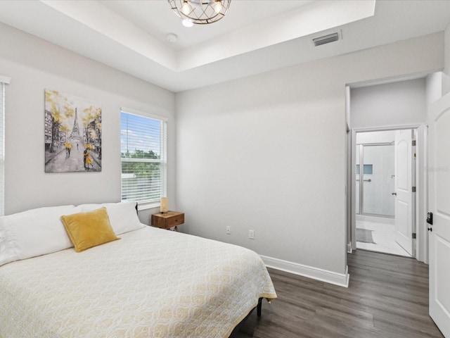2809 N 21st St, Tampa, FL 33605 - bedroom with dark wood-style flooring, ensuite bath, and a tray ceiling