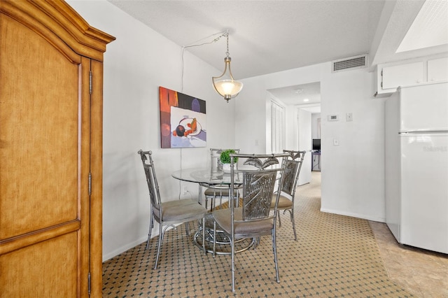 9755 Harrell Ave Unit 101, Treasure Island, FL 33706 - dining room with baseboards and carpet floors