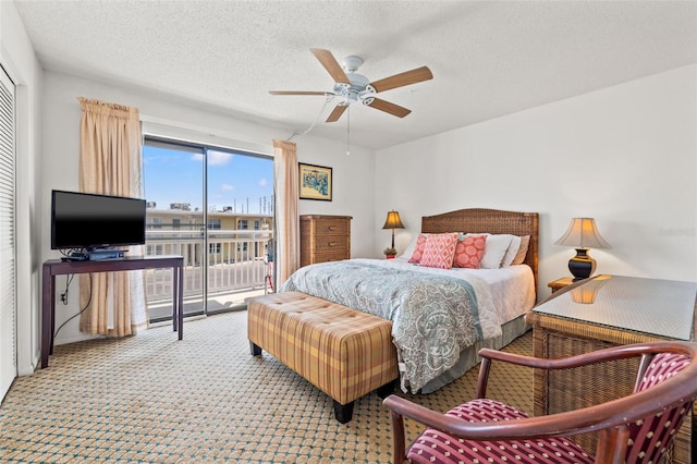 9755 Harrell Ave Unit 101, Treasure Island, FL 33706 - bedroom with access to outside, carpet flooring, a textured ceiling, and a ceiling fan