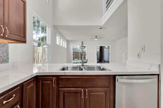 3412 W San Juan St Unit A, Tampa, FL 33629 - kitchen featuring stainless steel dishwasher, healthy amount of natural light, a peninsula, and light countertops