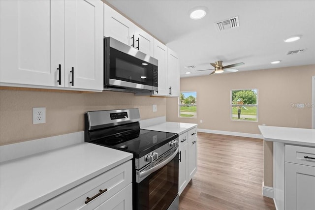 21536 Holdern Ave, Port Charlotte, FL 33952 - kitchen with stainless steel appliances, a ceiling fan, light countertops, white cabinets, and recessed lighting