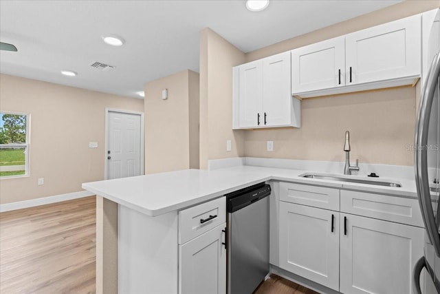 21536 Holdern Ave, Port Charlotte, FL 33952 - kitchen with appliances with stainless steel finishes, a sink, a peninsula, recessed lighting, and white cabinets