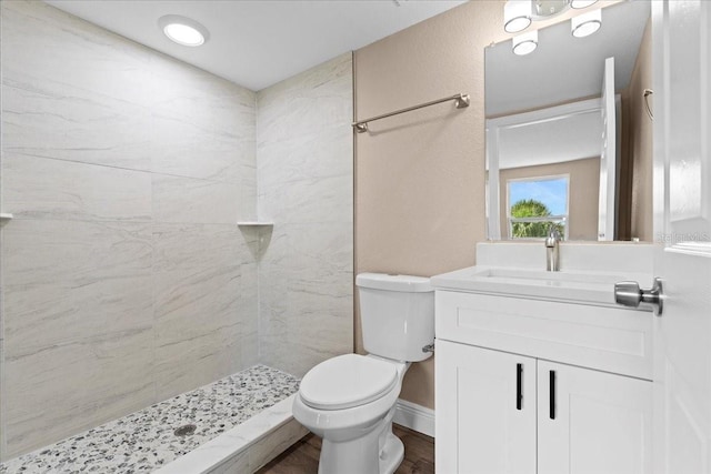 21536 Holdern Ave, Port Charlotte, FL 33952 - bathroom featuring toilet, vanity, a tile shower, and wood finished floors