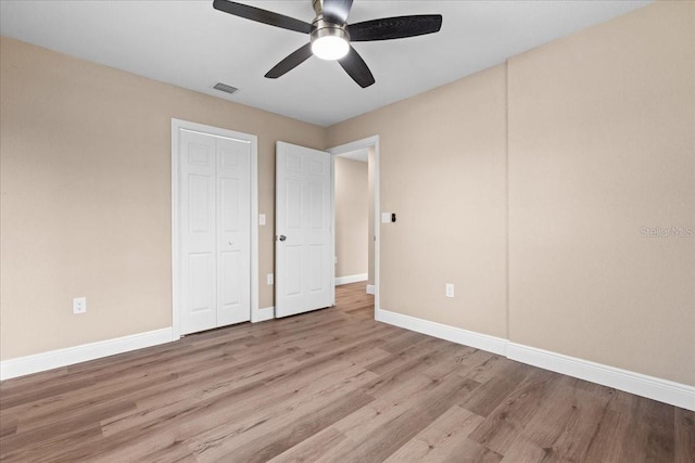 21536 Holdern Ave, Port Charlotte, FL 33952 - unfurnished bedroom featuring light wood-type flooring, baseboards, ceiling fan, and a closet