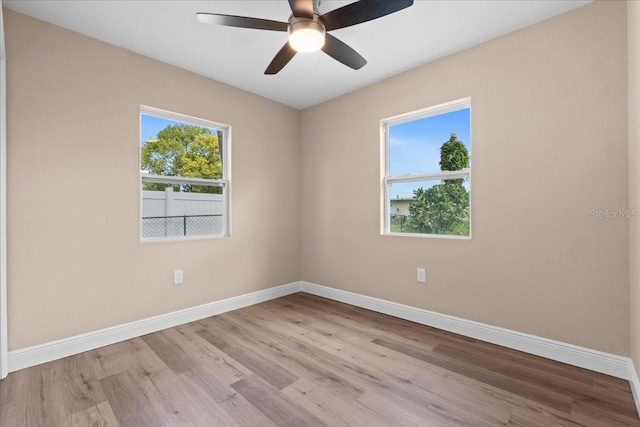 21536 Holdern Ave, Port Charlotte, FL 33952 - empty room featuring baseboards, wood finished floors, and a ceiling fan