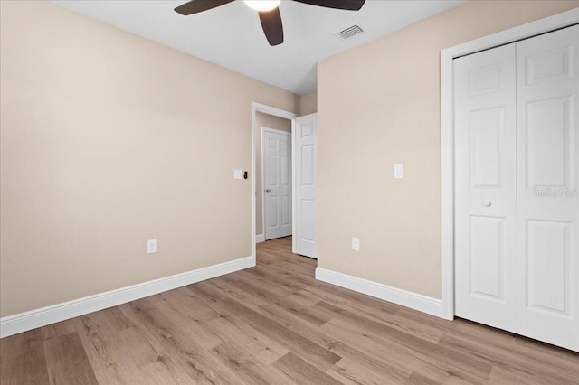 21536 Holdern Ave, Port Charlotte, FL 33952 - unfurnished bedroom with baseboards, light wood-style flooring, a closet, and a ceiling fan