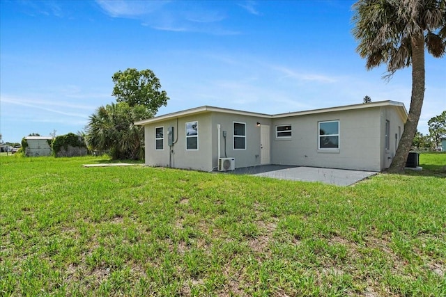 21536 Holdern Ave, Port Charlotte, FL 33952 - back of property with a patio area, a yard, central AC unit, and a cooling unit