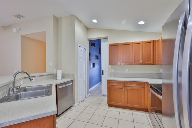 11415 Bright Star Ln, Riverview, FL 33569 - kitchen featuring appliances with stainless steel finishes, a sink, lofted ceiling, light tile patterned floors, and light countertops