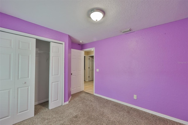 11415 Bright Star Ln, Riverview, FL 33569 - unfurnished bedroom featuring carpet, a closet, a textured ceiling, and baseboards